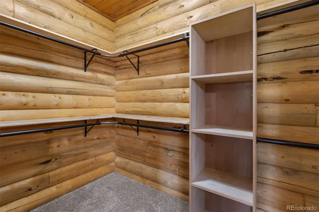 a view of walk in closet with empty racks