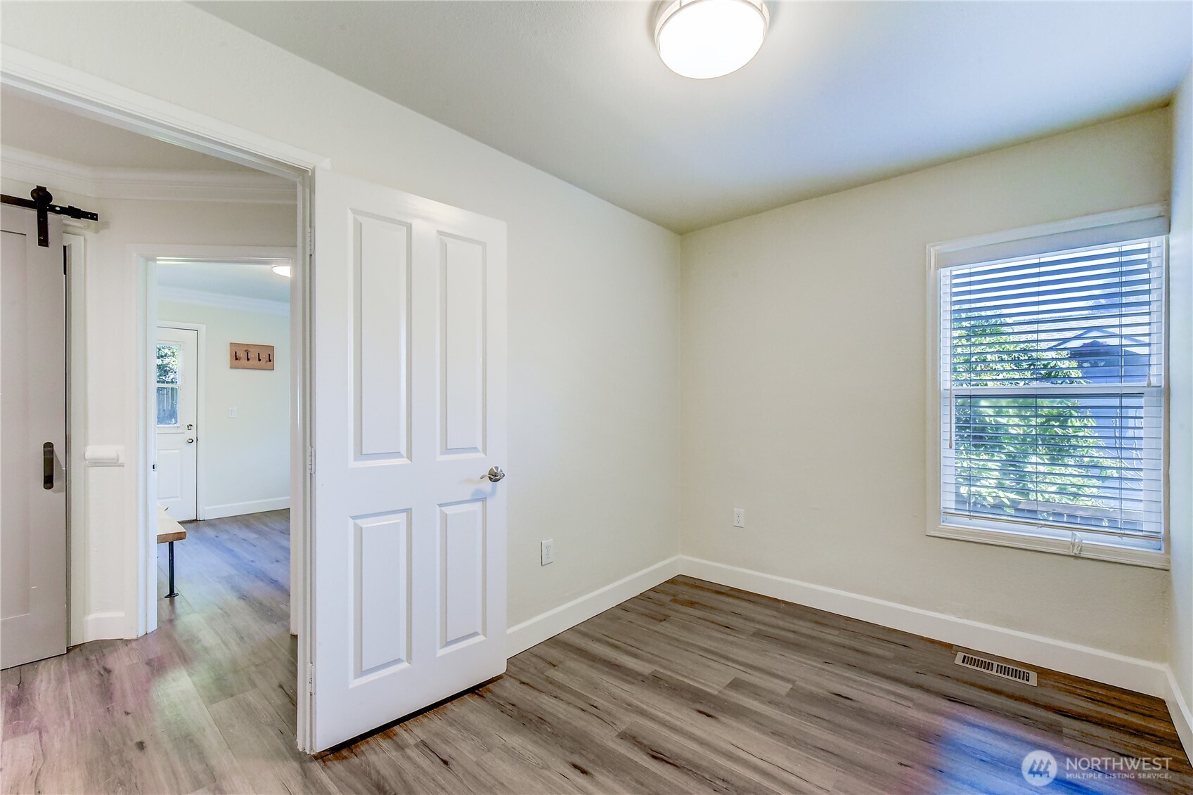 1048 South Director Street Seattle, WA 98108 - Photo 13 of 20 a view of an empty room with wooden floor and a window