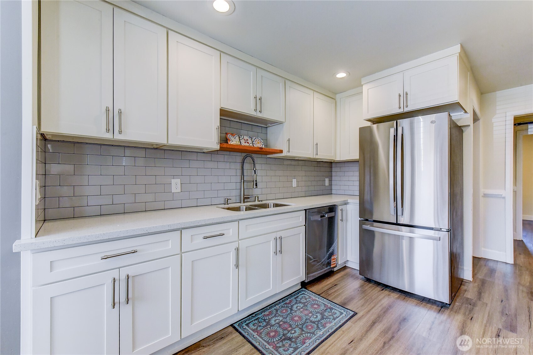 1048 South Director Street Seattle, WA 98108 - Photo 7 of 20 a kitchen with stainless steel appliances granite countertop a refrigerator sink and cabinets