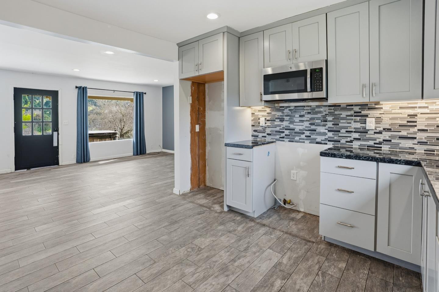 17918 Pesante Road Prunedale, CA 93907 - Photo 11 of 35 a kitchen with granite countertop a refrigerator stove and microwave