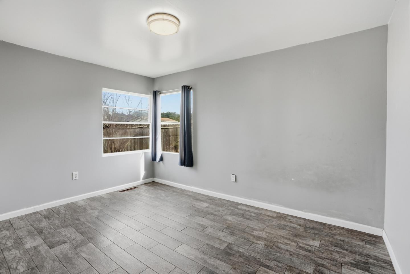 17918 Pesante Road Prunedale, CA 93907 - Photo 25 of 35 an empty room with wooden floor and windows