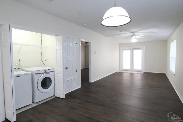 a view of a kitchen with wooden floor and a window