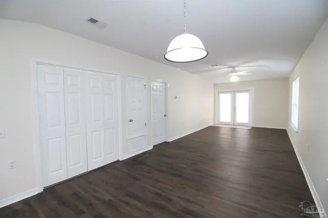 a view of wooden floor and windows in a room