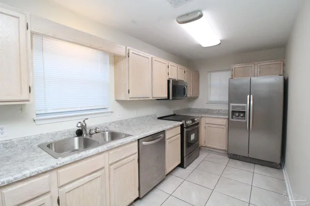a kitchen with a sink appliances and cabinets