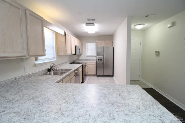 a kitchen with stainless steel appliances granite countertop a refrigerator sink and cabinets