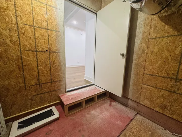 a utility room with lots of racks on the wall