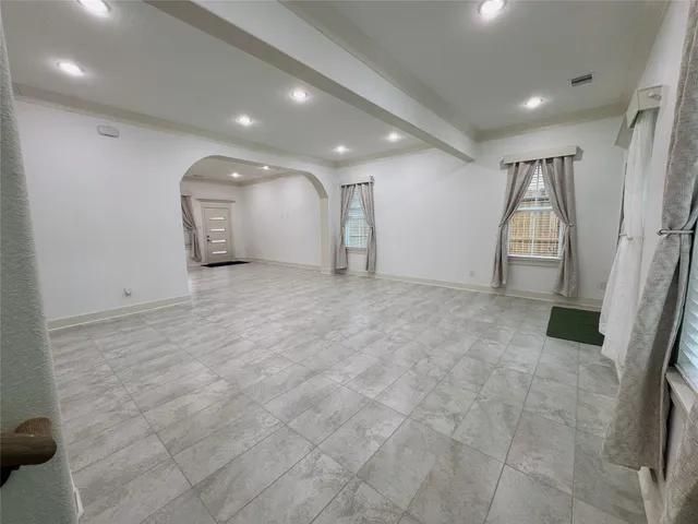 a kitchen with refrigerator and chairs