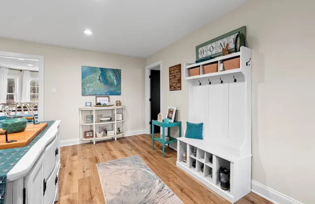 a living room with stainless steel appliances kitchen island granite countertop furniture and a dining table with kitchen view