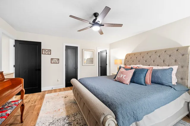 a view of a workspace with furniture and wooden floor