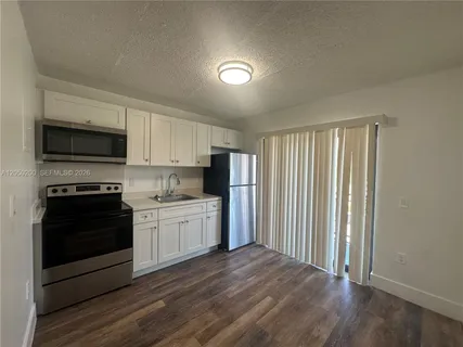 a kitchen with appliances cabinets and a sink