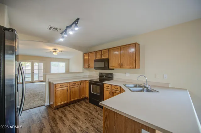 a bathroom with a sink a mirror a vanity and a shower