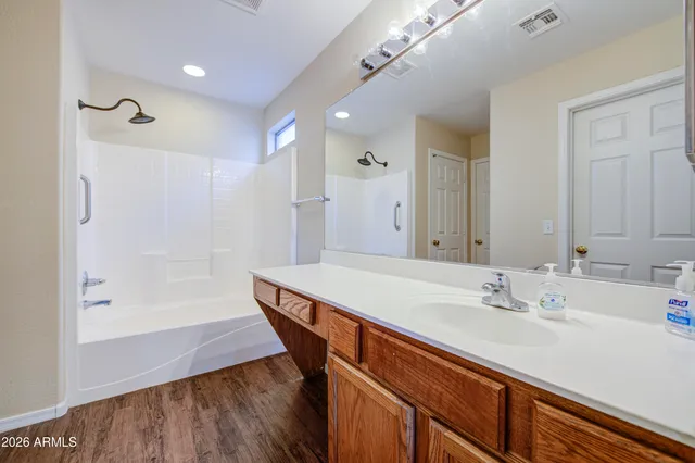a bathroom with a bath tub with a shower