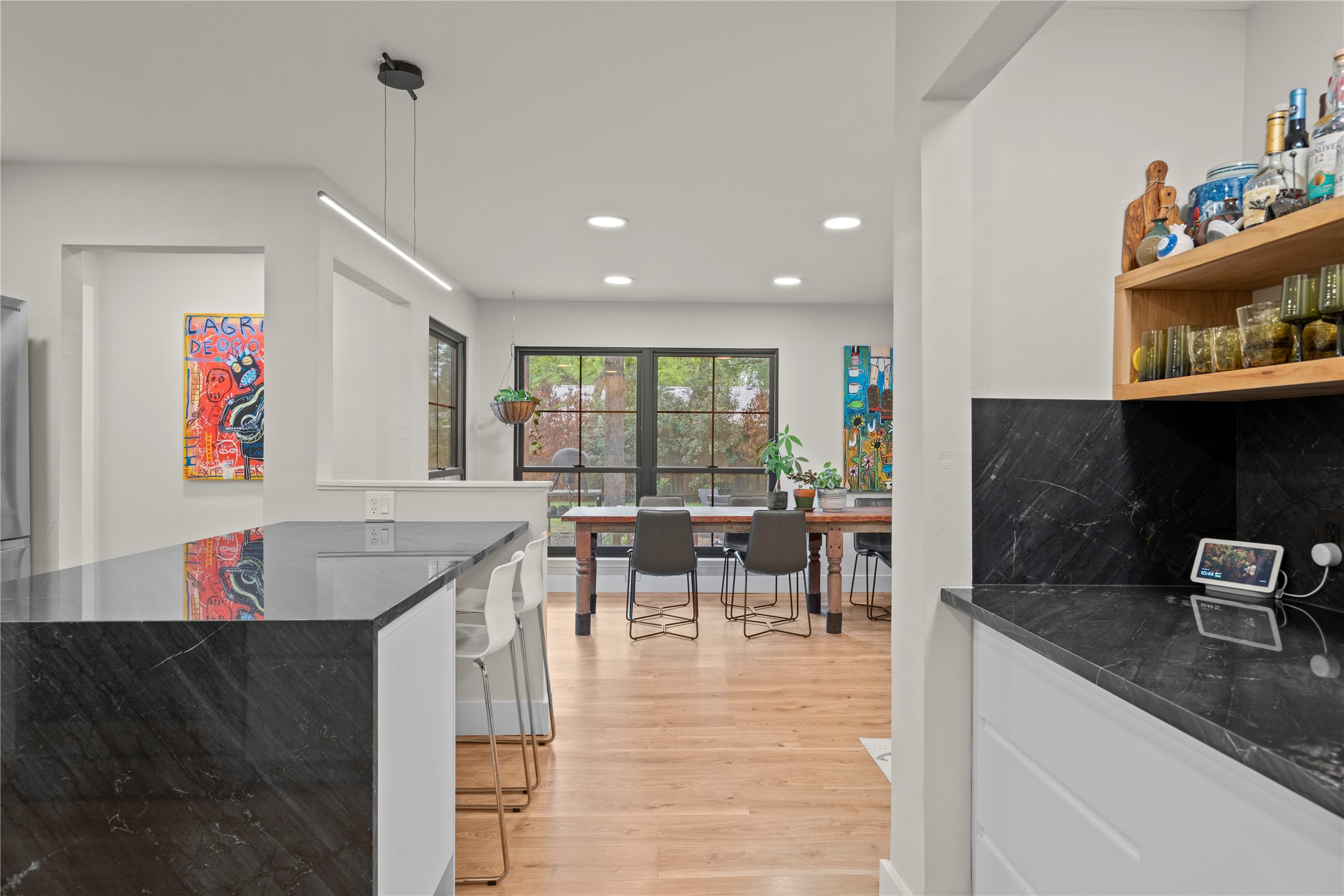 7107 Greenock Street Austin, TX 78749 - Photo 13 of 40 The kitchen features dark countertops, recessed lighting, and a linear pendant light fixture