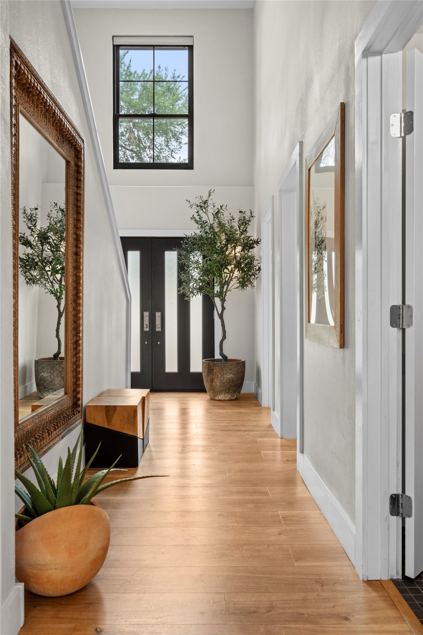 7107 Greenock Street Austin, TX 78749 - Photo 19 of 40 Spacious entryway featuring light wood flooring, a tall ceiling, and a large window providing natural light