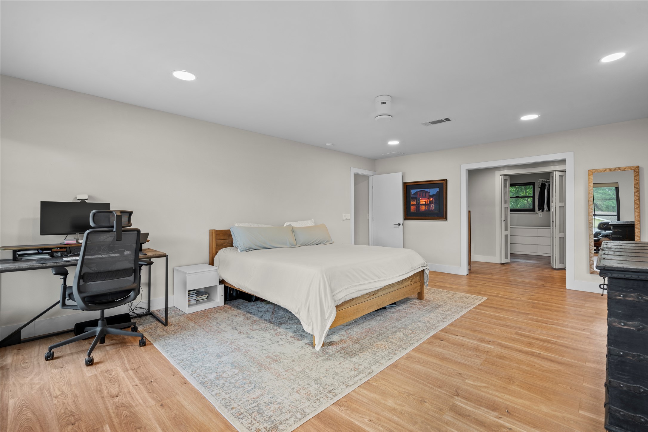 7107 Greenock Street Austin, TX 78749 - Photo 20 of 40 The property features light wood flooring, recessed ceiling lights, and a ceiling fan