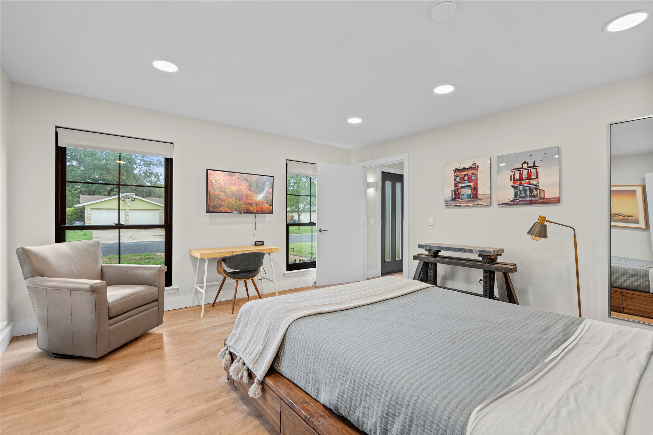 7107 Greenock Street Austin, TX 78749 - Photo 25 of 40 This room features light hardwood flooring, recessed lighting, and windows with dark frames