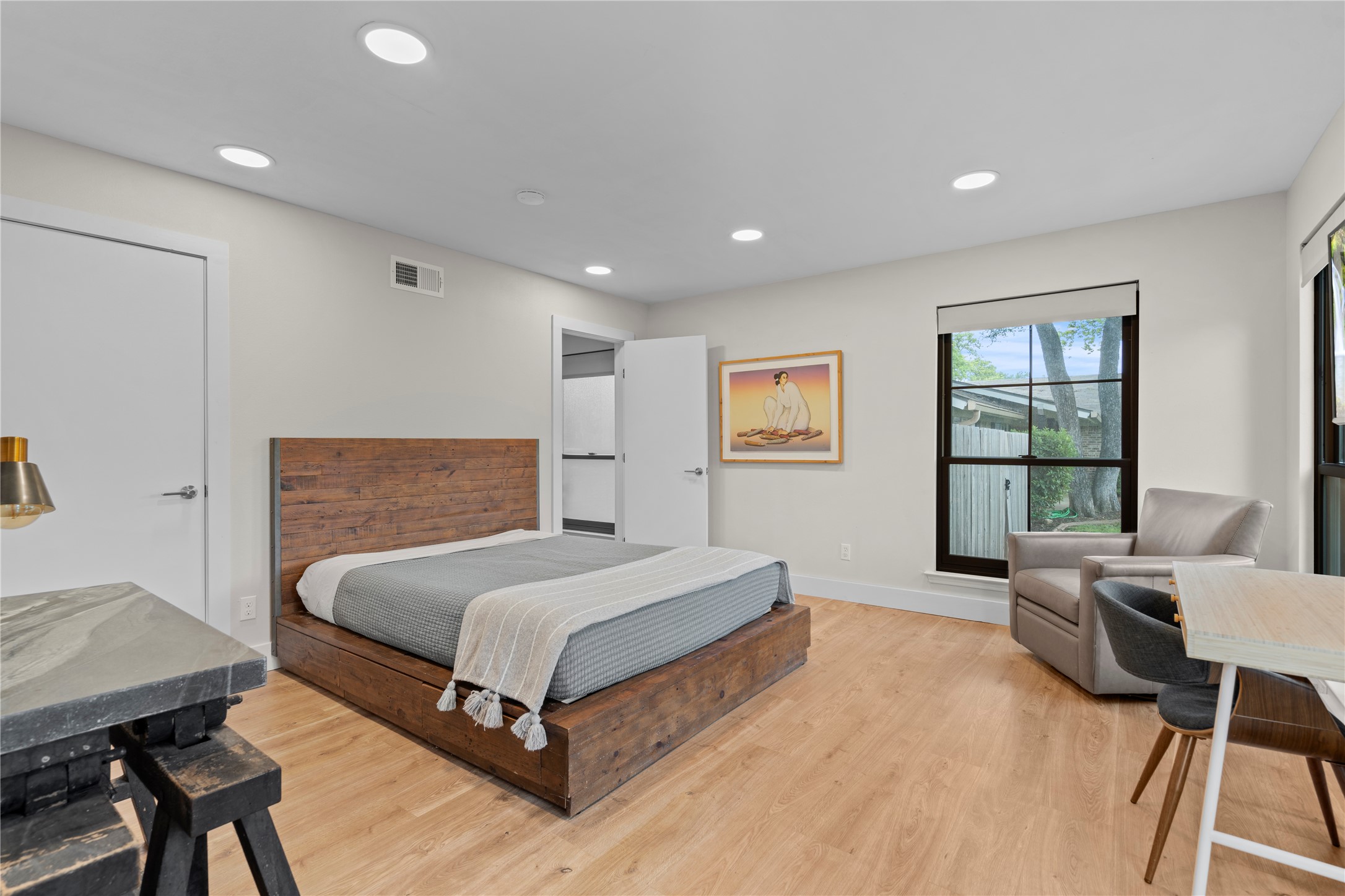 7107 Greenock Street Austin, TX 78749 - Photo 26 of 40 This room features light wood-style flooring, recessed lighting, and a window with a view of exterior trees and fencing