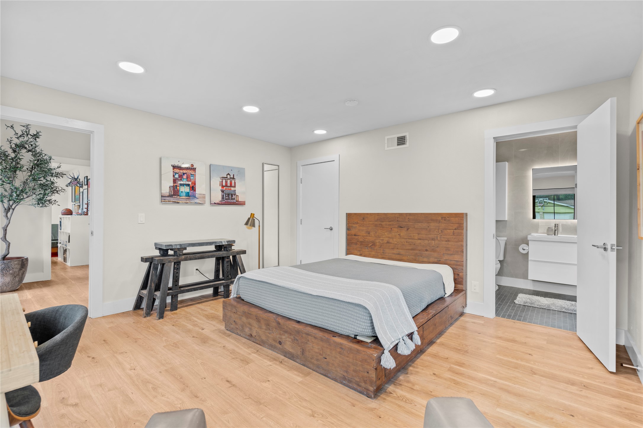 7107 Greenock Street Austin, TX 78749 - Photo 27 of 40 The property features recessed lighting, light wood flooring, and a bedroom with a solid wood bed frame