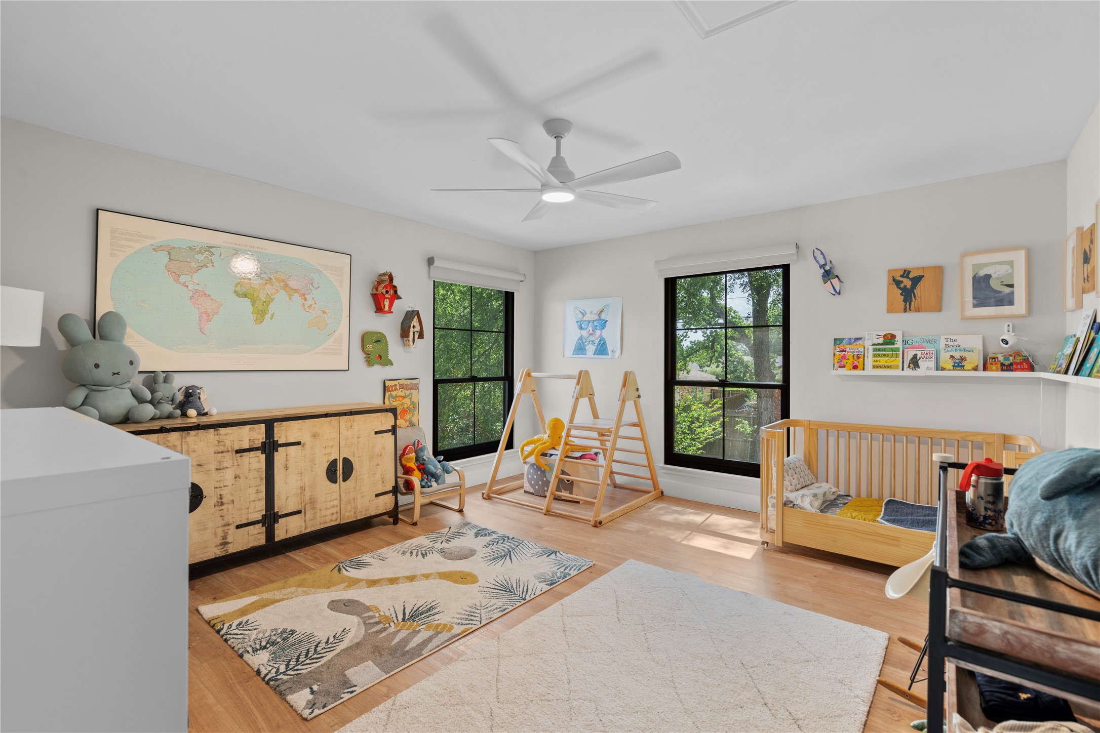 7107 Greenock Street Austin, TX 78749 - Photo 31 of 40 This bright room features two large windows with dark frames, a ceiling fan, and light-colored flooring