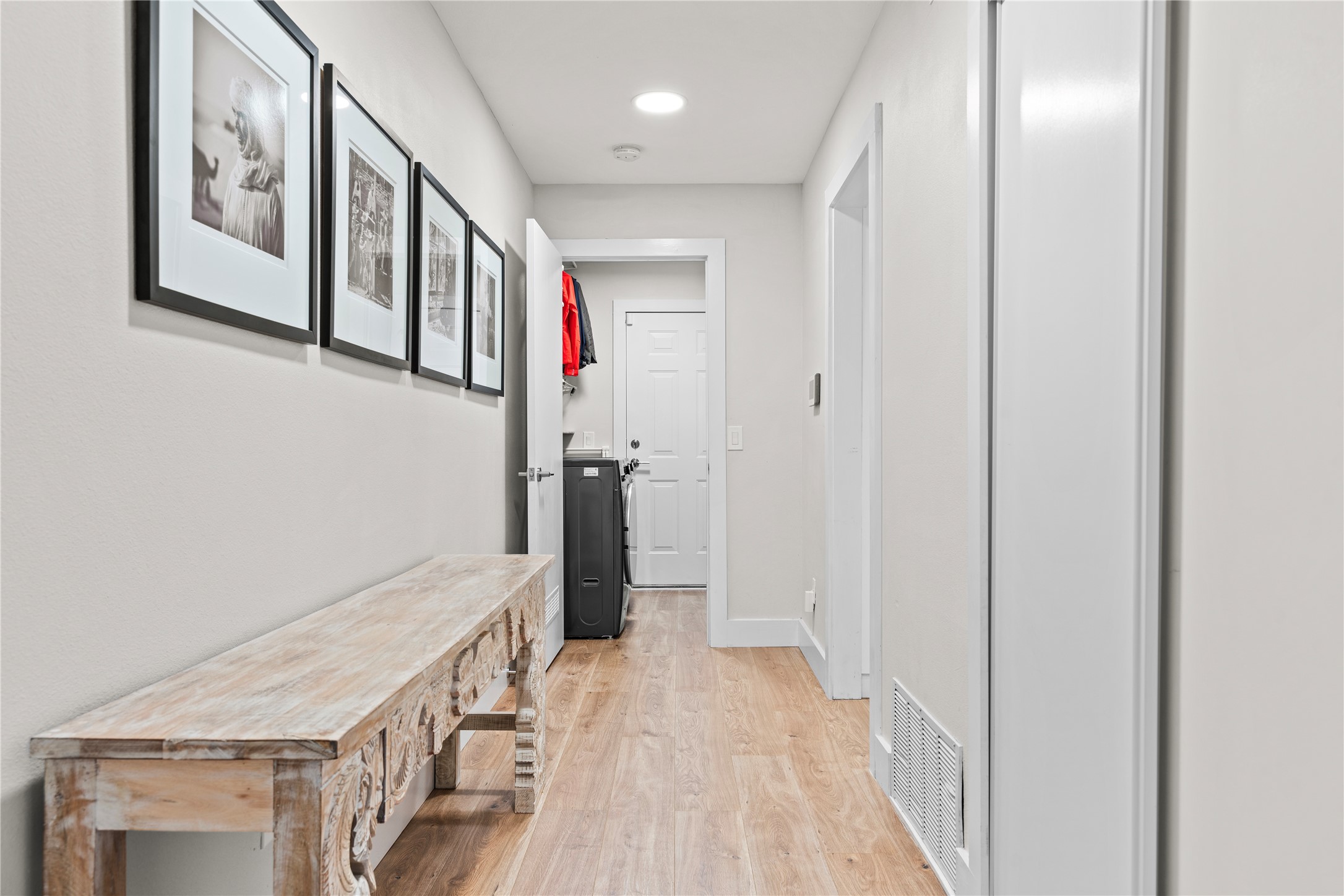 7107 Greenock Street Austin, TX 78749 - Photo 34 of 40 The property features a hallway with light wood flooring, recessed lighting, and white walls