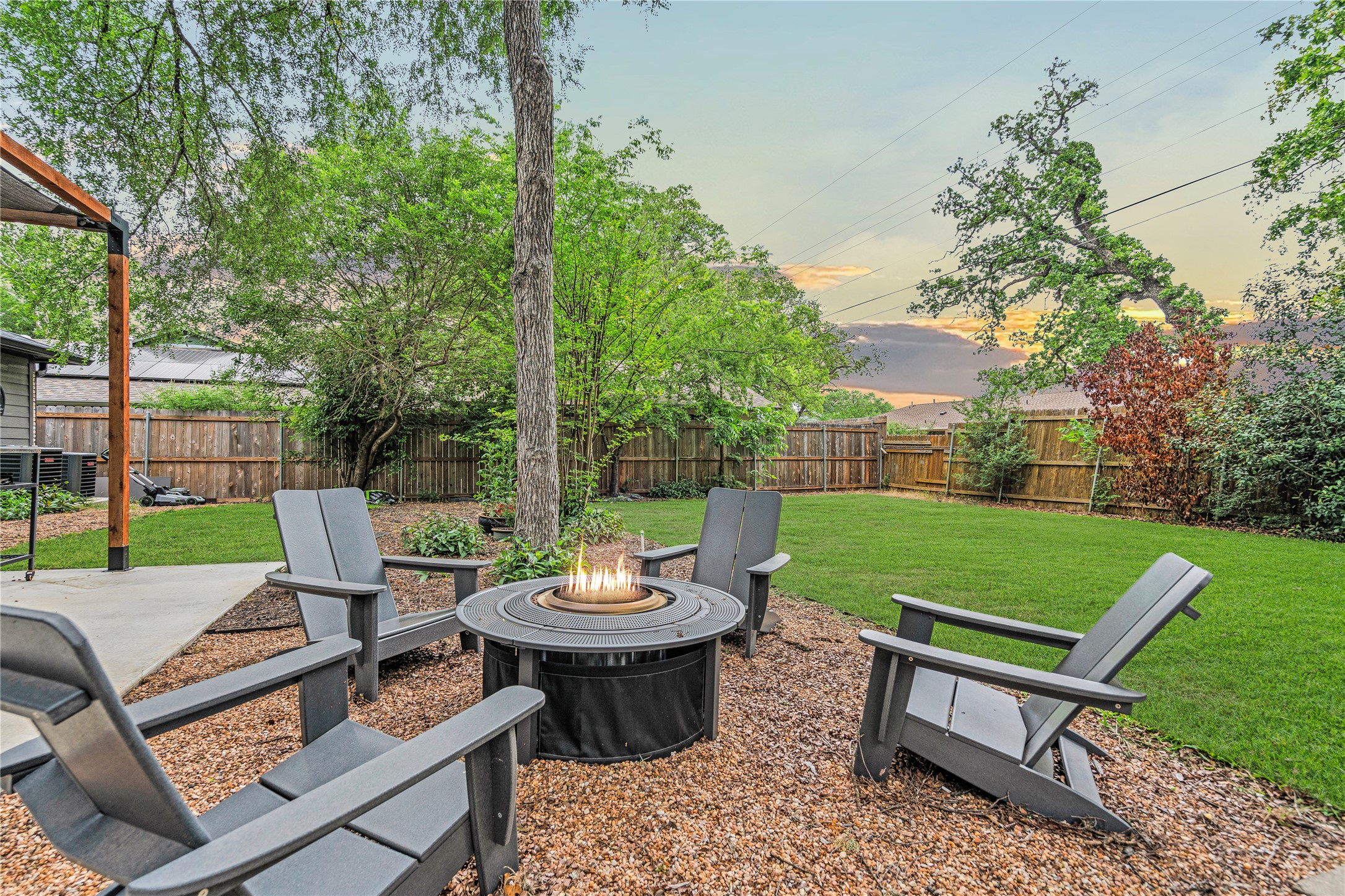 7107 Greenock Street Austin, TX 78749 - Photo 36 of 40 The property features an outdoor living area with a fire pit, surrounded by a gravel patio