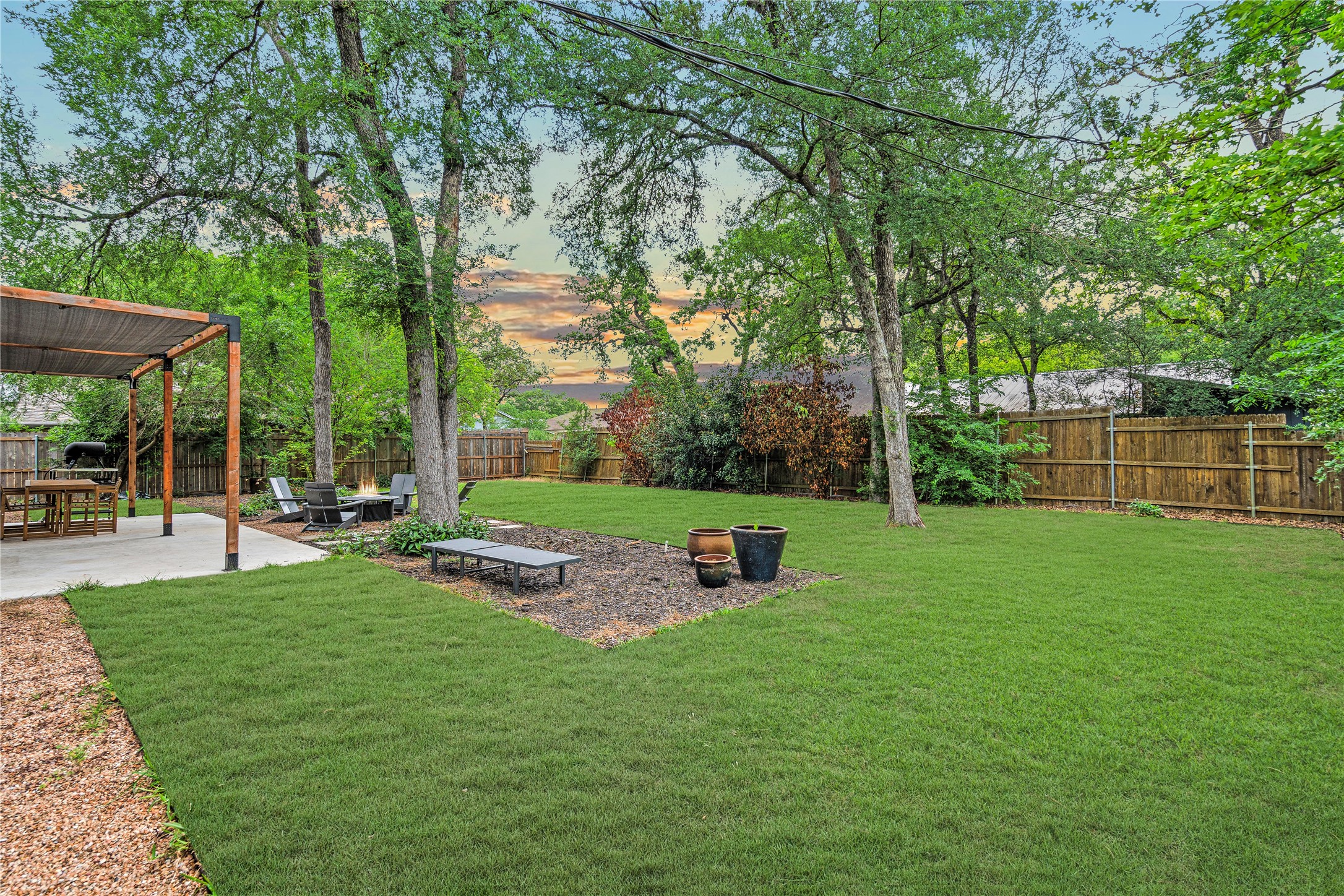 7107 Greenock Street Austin, TX 78749 - Photo 37 of 40 The property features an expansive yard with a well-maintained lawn and mature trees