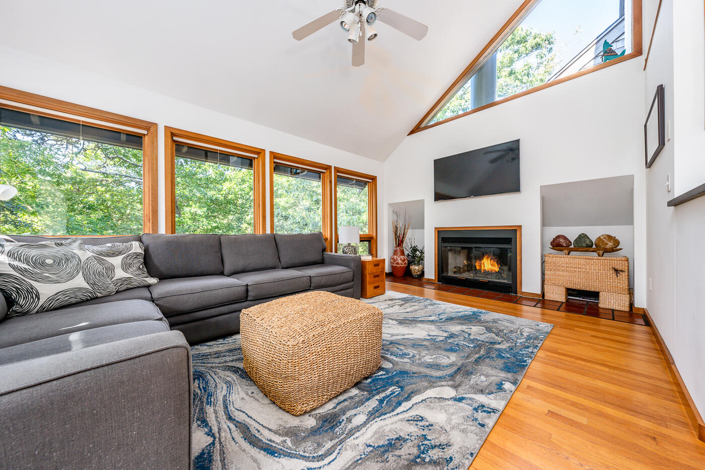 256 Browns Neck Road Wellfleet, MA 02667 - Photo 5 of 66 a living room with furniture a large window and a fireplace