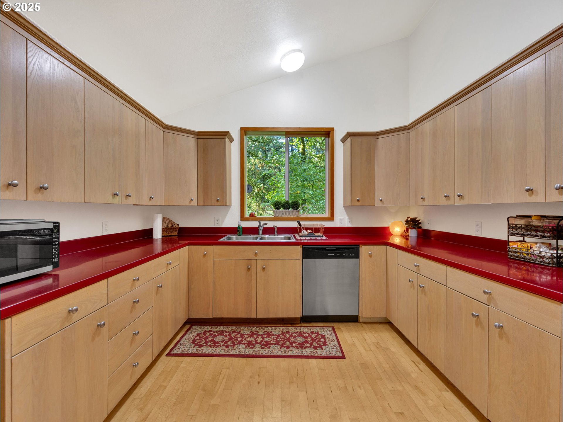 64079 East Barlow Trail Road Rhododendron, OR 97049 - Photo 11 of 48 a kitchen with a refrigerator sink and cabinets