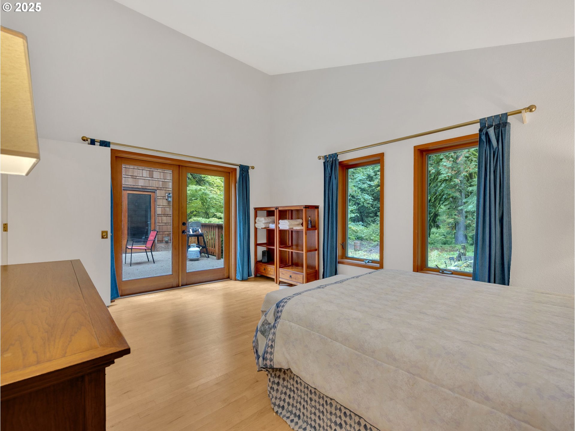 64079 East Barlow Trail Road Rhododendron, OR 97049 - Photo 19 of 48 a bedroom with a large bed and a large window