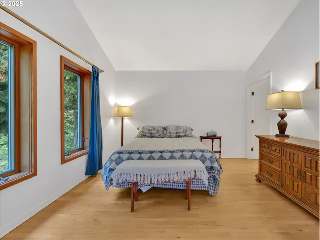 a bedroom with a large bed and a window