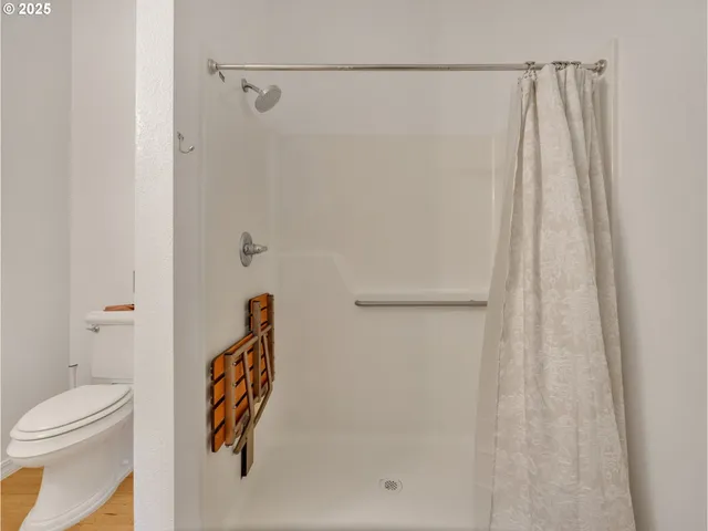 a bathroom with a shower curtain and a toilet