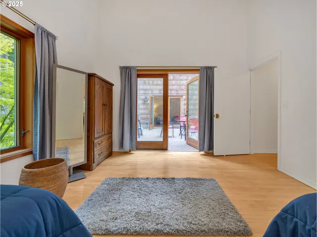 a view of a bedroom with furniture and a window