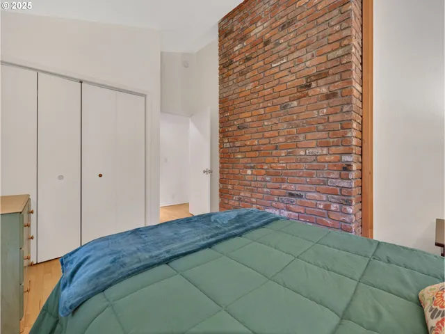 a bedroom with a bed and a plant