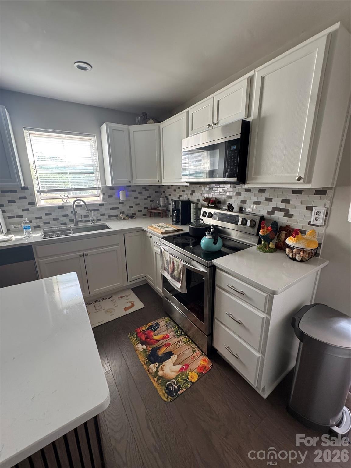 1319 Rollings Roost Road Lancaster, SC 29720 - Photo 5 of 29 a kitchen with stainless steel appliances a stove a sink dishwasher a refrigerator white cabinets and wooden floor
