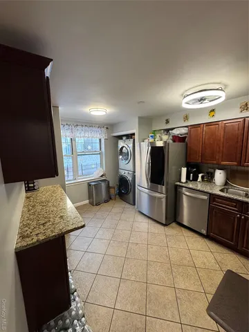 a kitchen with stainless steel appliances kitchen island granite countertop a sink and stove
