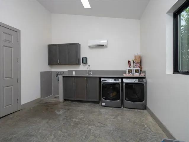 a dining room with a large window and white appliances