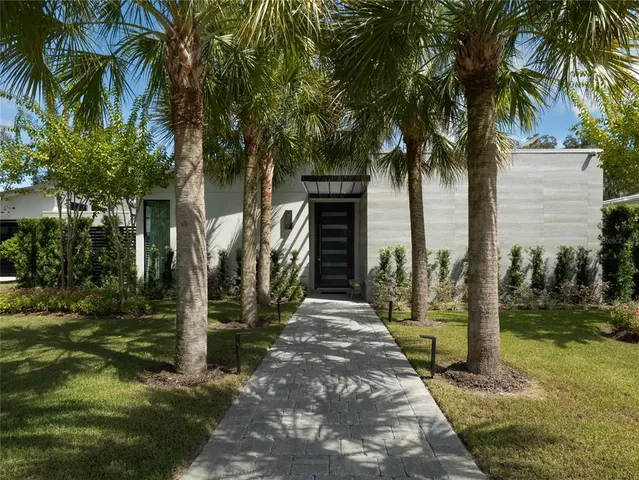 a dining hall with stainless steel appliances granite countertop a stove a refrigerator a sink dishwasher a dining table and chairs with wooden floor