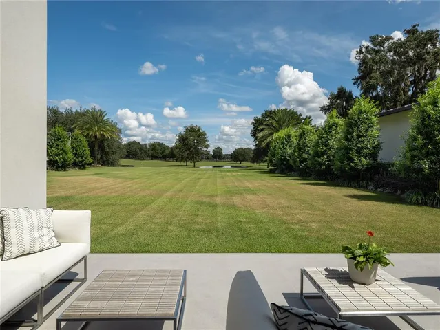 an aerial view of a house with a yard lake view and mountain view