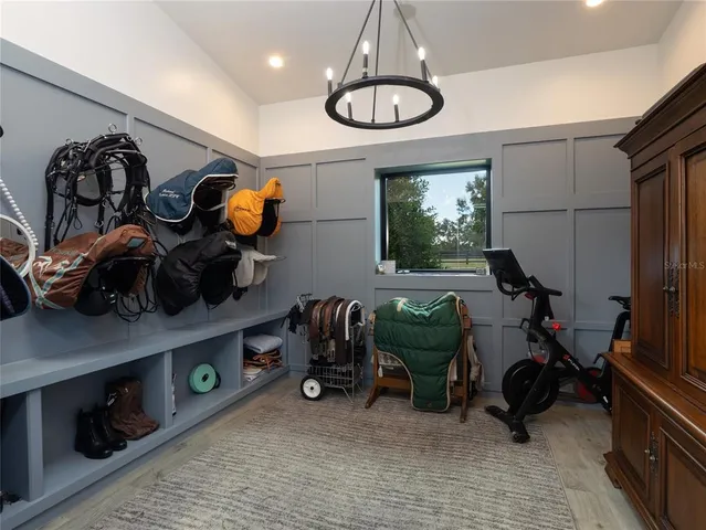 a view of a hallway with wooden floor and windows