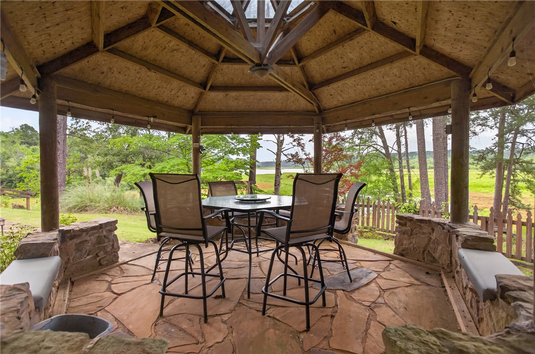 351 River Road Westminster, SC 29693 - Photo 42 of 50 A spacious gazebo with flagstone flooring offers serene lake views, perfect for outdoor relaxation and entertaining.