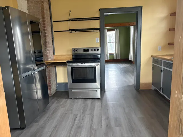 a kitchen with stainless steel appliances a refrigerator and a stove top oven