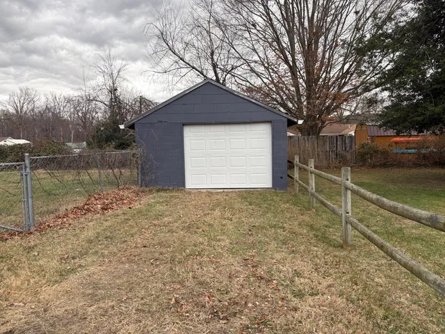 a front view of house with yard and trees