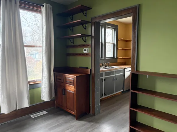 a kitchen with window and cabinets