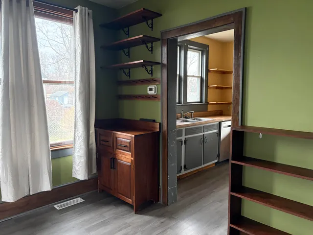 a kitchen with window and cabinets