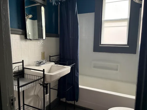 a bathroom with a bath tub and a sink