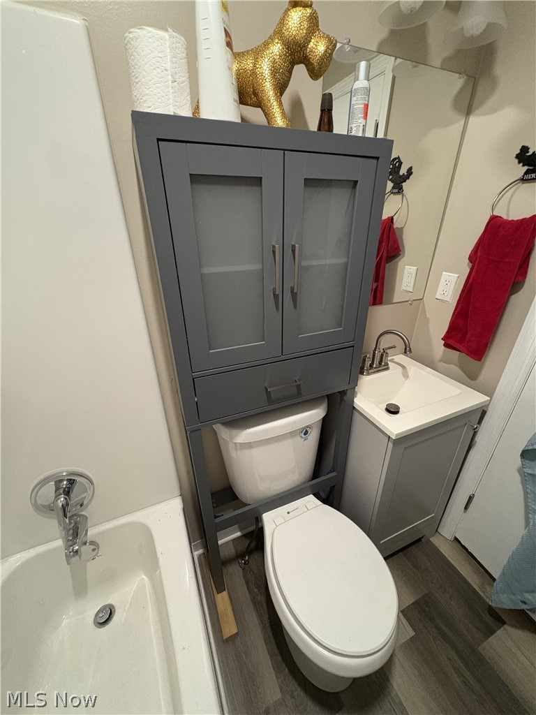 727 Wooster Road North Barberton, OH 44203 - Photo 34 of 37 Studio's Bathroom featuring a white toilet, coordinating vanity with a white countertop and chrome faucet, and LVP flooring