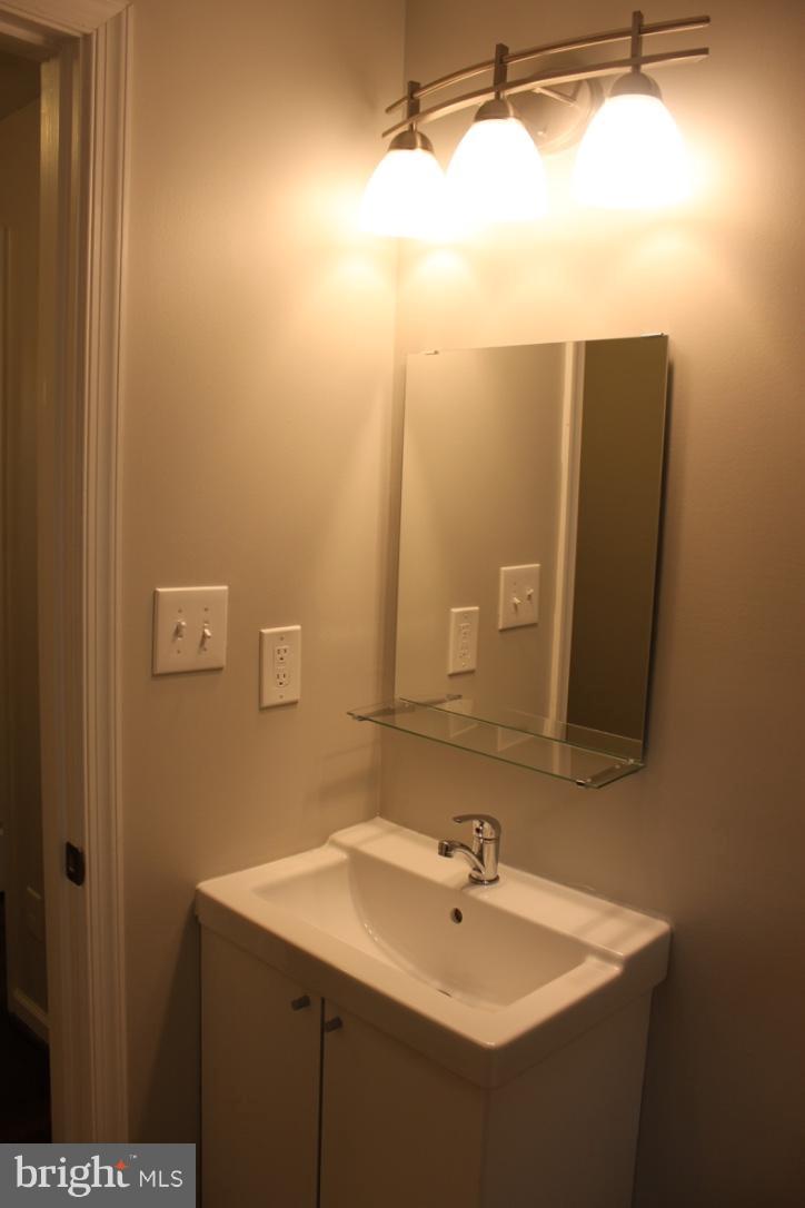 1654 Riverwood Road Baltimore, MD 21221 - Photo 11 of 30 a bathroom with a sink and a mirror