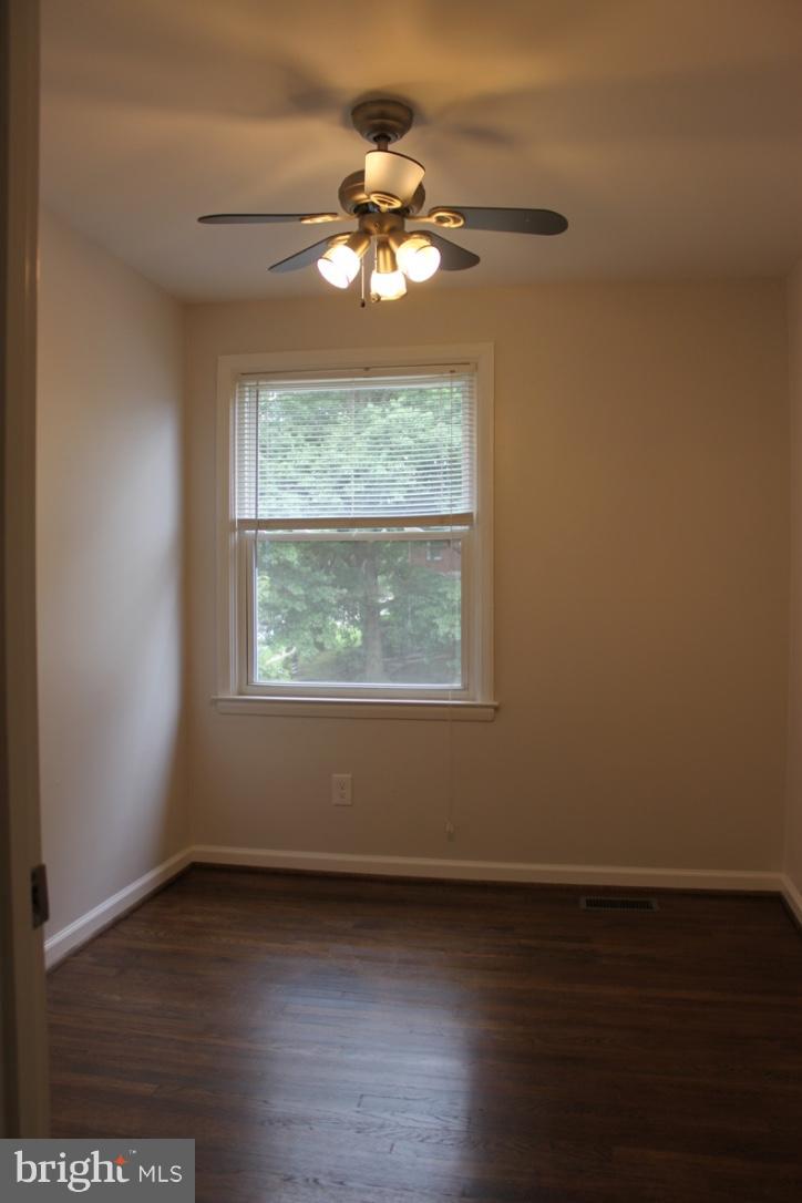1654 Riverwood Road Baltimore, MD 21221 - Photo 17 of 30 an empty room with wooden floor and windows
