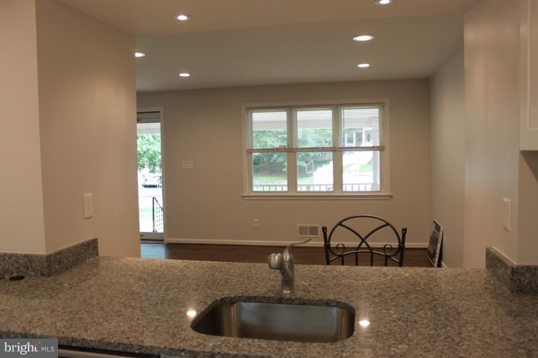 1654 Riverwood Road Baltimore, MD 21221 - Photo 4 of 30 a kitchen with granite countertop a sink and a window