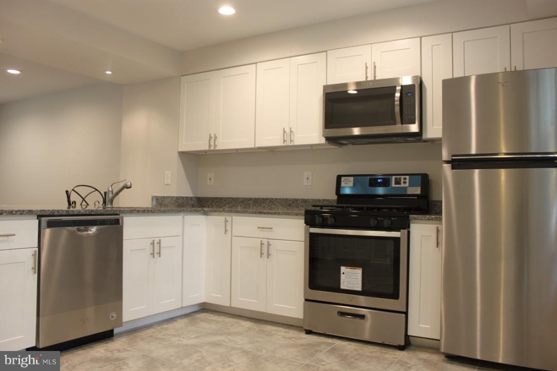 1654 Riverwood Road Baltimore, MD 21221 - Photo 7 of 30 a kitchen with a refrigerator stove and microwave